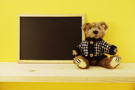 teddy bear and space copy background on yellow backgroundの写真素材