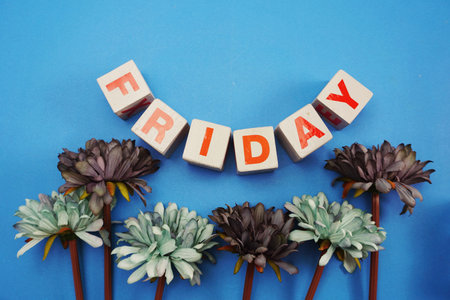 friday alphabet letters with daisy flower on blue backgroundの写真素材