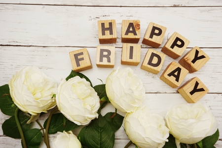 happy friday alphabet letters with peony flower on wooden backgroundの写真素材