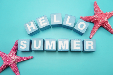 Hello Summer alphabet letter and colorful starfish decoration on Blue backgroundの写真素材