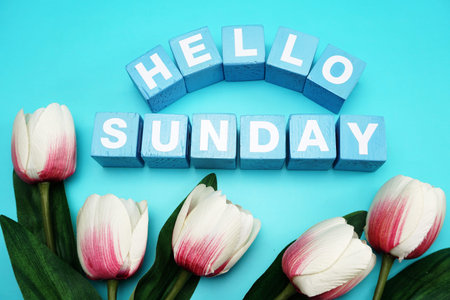 hello sunday with blue wooden cubes alphabet letter on blue background
