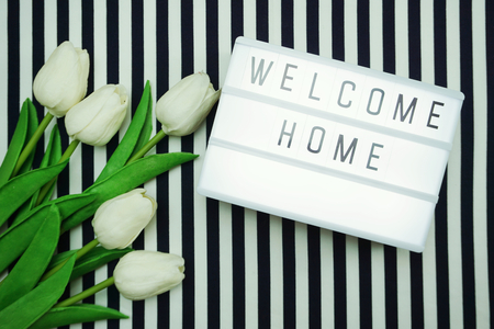 Welcome Home Light box letters Top view Flat Lay with tulip flower bouquetの写真素材