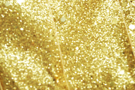 abstract defocused shiny sparkle gold glitter bokeh backgroundの写真素材