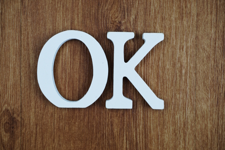 OK alphabet letters on wooden backgroundの写真素材