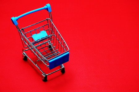 Mini trolley cart on red backgroundの写真素材