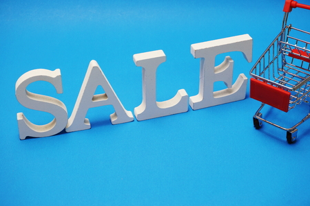 Sale and Mini Trolley Cart on blue backgroundの写真素材