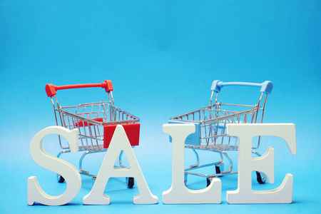 Sale and Mini Trolley Cart on blue backgroundの写真素材