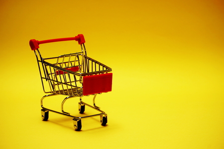 Mini trolley cart on yellow backgroundの写真素材
