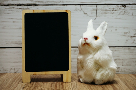 happy easter with bunny rabbit and space copy wooden easel backgroundの写真素材