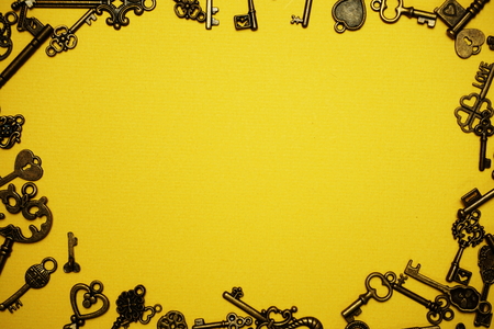 Many different retro vintage keys with space copy on yellow  backgroundの写真素材