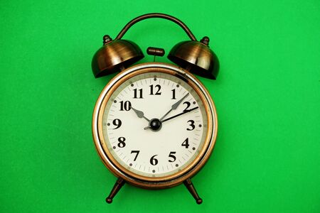 vintage alarm clock with space copy on green backgrounの写真素材