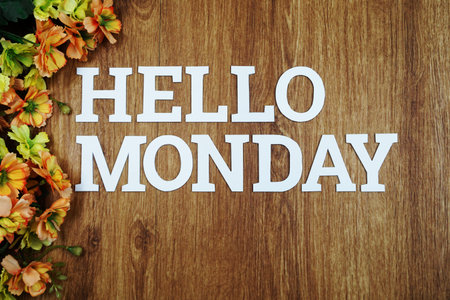 Hello Monday wooden letter alphabet with flower on wooden background