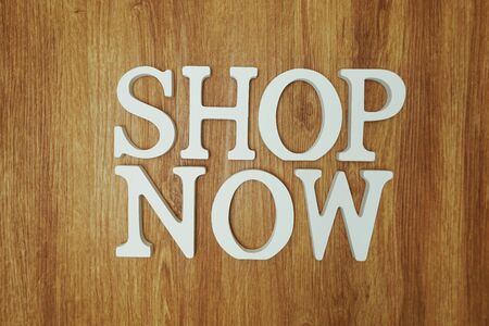 Shop Now word alphabet letters on wooden backgroundの写真素材
