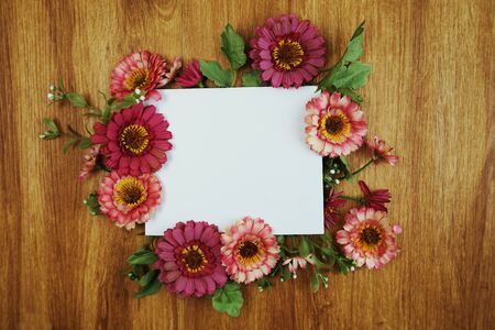 Flat lay of flowers and space copy on wooden backgroundの写真素材