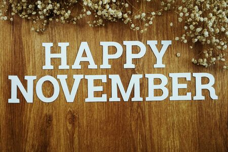Happy November alphabet letters on wooden backgroundの写真素材