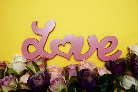Love word alphabet and roses bouquet with space copy on Yellow backgroundの写真素材