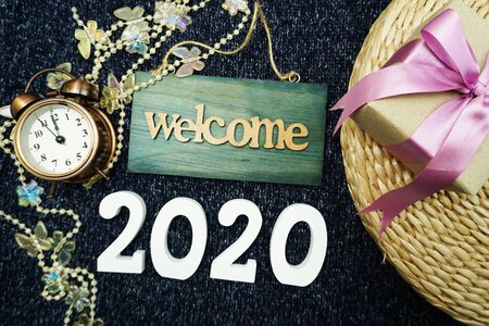 Happy New Year 2020 with welcome sign, gift box and alarm clock decoration backgroundの写真素材