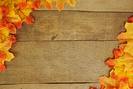 Autumn Maple leave border frame with space copy on wooden background