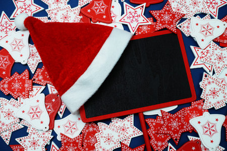 Christmas Holiday background and space copy on wooden black board flat lay on blue background