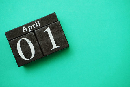 April 1st wooden calendar with space copy on green mint backgroundの写真素材