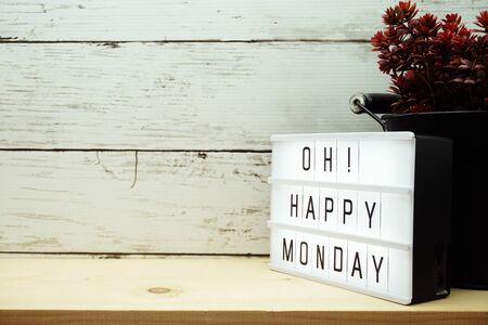 Happy Monday light box alphabet wording on wooden backgroundの写真素材