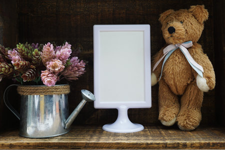 Blank Display frame stand with artificial plant home decoration on wooden backgroundの写真素材