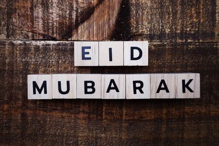 Eid Mubarak alphabet letter on wooden backgroundの写真素材
