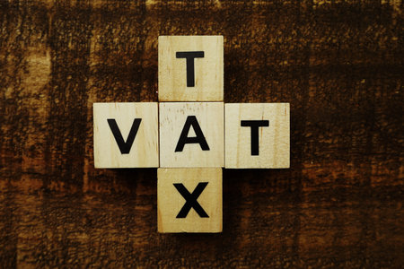 Tax and Vat alphabet letters on wooden background