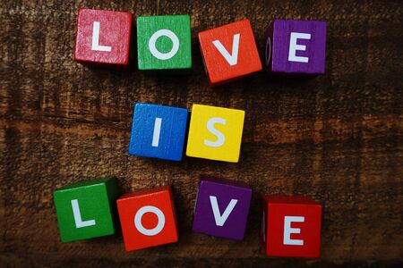 Love is Love word colorful alphabet letter with space copy on wooden backgroundの写真素材