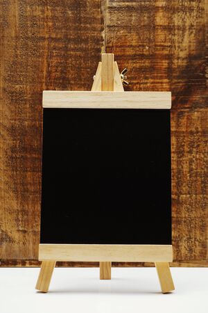 Space wooden easel on wooden backgroundの写真素材