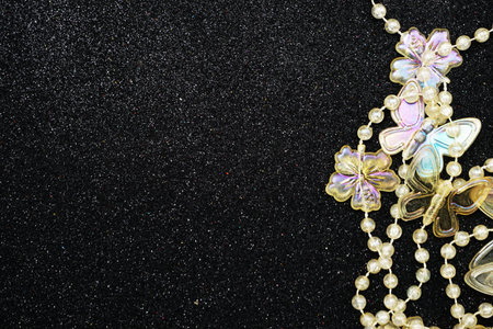 Butterfly and flower garland decoration with space copy on Black glitter backgroundの写真素材