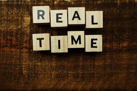 Real Time alphabet letters on wooden backgroundの写真素材