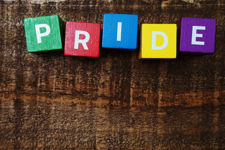 Pride alphabet letter with space copy on wooden background