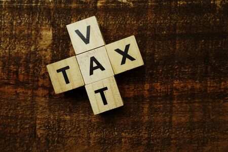 Tax and Vat alphabet letters on wooden backgroundの写真素材