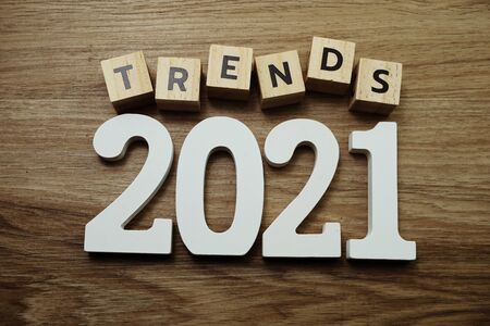 Trends 2021 word alphabet letters on wooden backgroundの写真素材