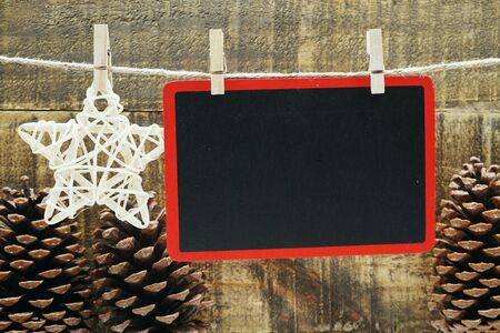 Wooden space copy hanging with wooden clip and rope on wooden backgroundの写真素材