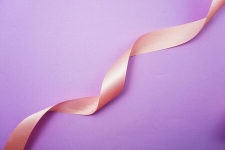 Spiral Pink ribbon on purple backgroundの写真素材