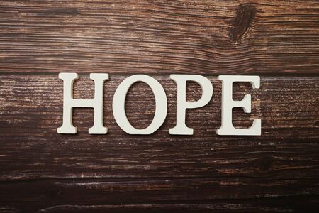 Hope alphabet letter on wooden backgroundの写真素材