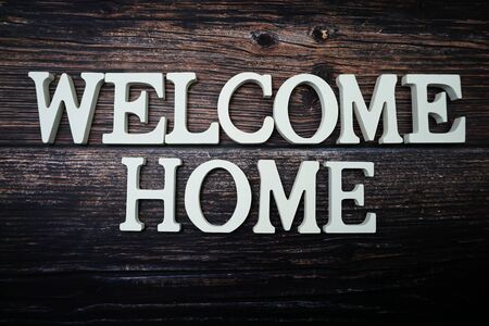 Welcome Home alphabet letter on wooden backgroundの写真素材