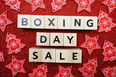 Boxing Day Sale alphabet letter with candy cane decoration on red glitter backgroundの写真素材