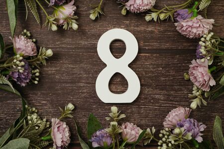 Women's day with 8 letter and tulip flowers bouquet with space copy on wooden backgroundの写真素材