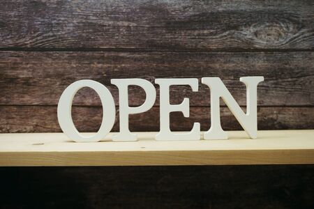 Open wooden alphabet letter on wooden backgroundの写真素材