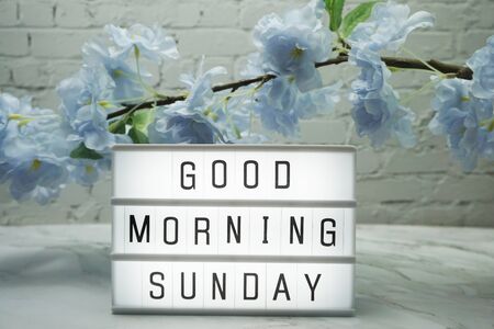 Good Morning Sunday word in light box with Flowers Decorationの写真素材