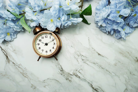 Vintage Alarm Clock And Tulip Bouquet with space copy on marble background