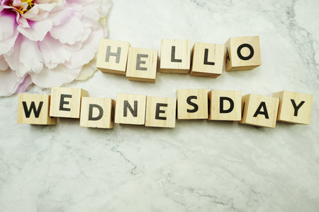 Hello Wednesday alphabet letter with space copy on marble background