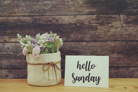 Hello Sunday Card with Blooming flower on wooden backgroundの写真素材