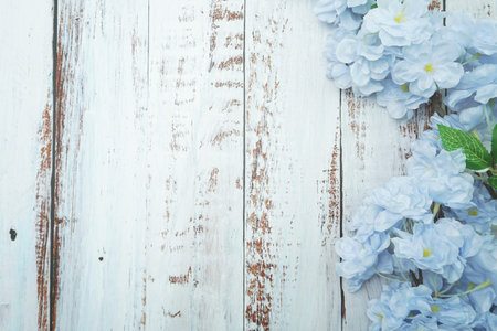 Top view Blooming Flowers frame with copy space on wooden backgroundの写真素材