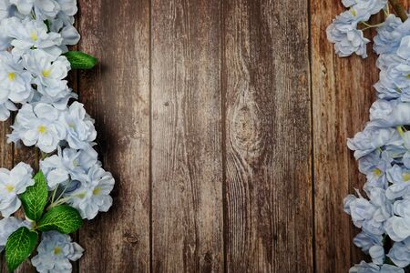 Top view Blooming Flowers frame with copy space on wooden backgroundの写真素材