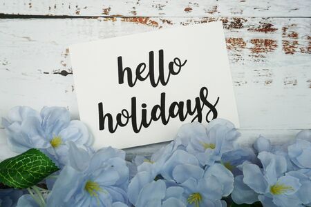 Hello Holiday Card with Blooming flower on wooden backgroundの写真素材