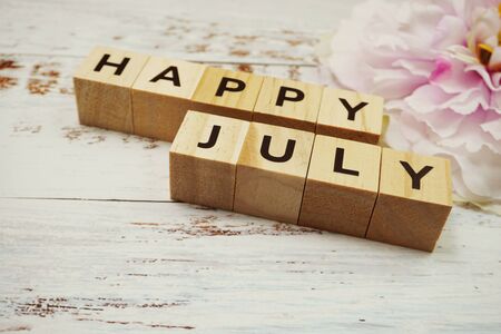 Happy July alphabet letters on wooden backgroundの写真素材
